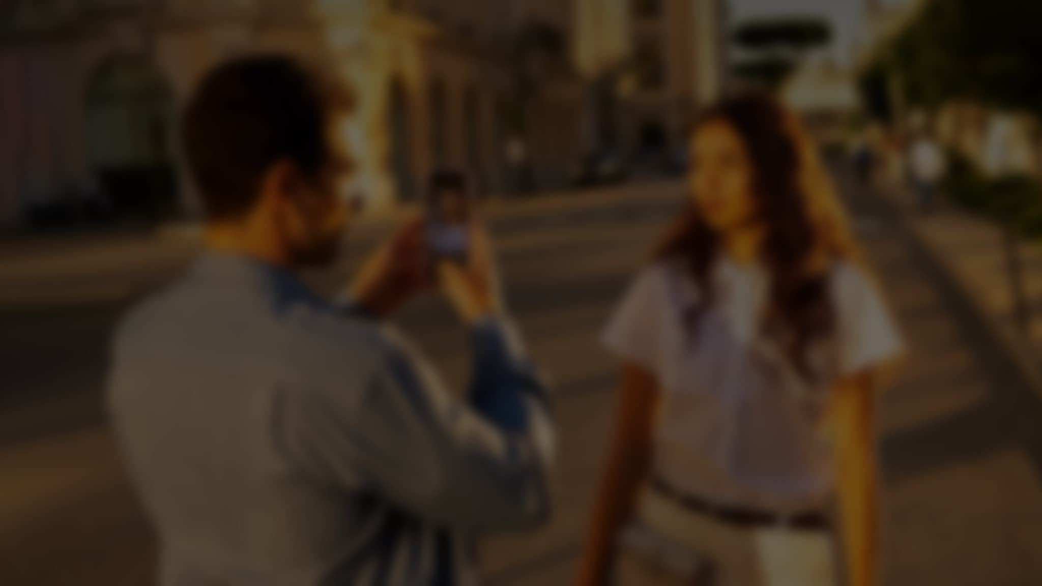 Woman on beach seen through smartphone camera